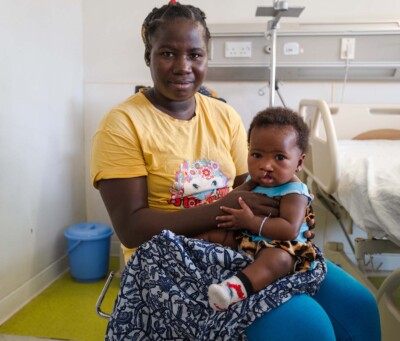 Mom poses with child during opening