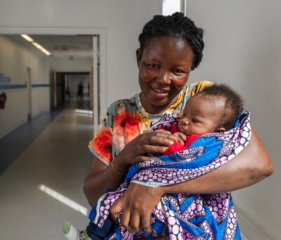 Mom smiles with baby