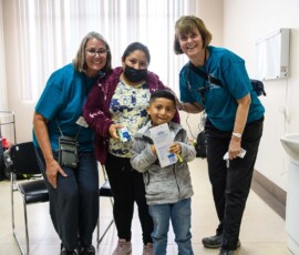 AfS’ dental team strike a pose with kid