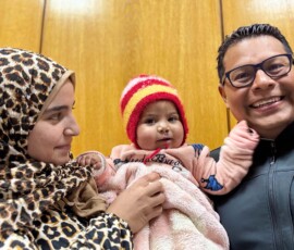 Baby plays with AfS volunteer